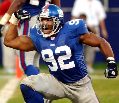 New York Giants defensive end Michael Strahan celebrates after sacking Seahawks quarterback Trent Dilfer during a game in 2002. (Associated Press)
