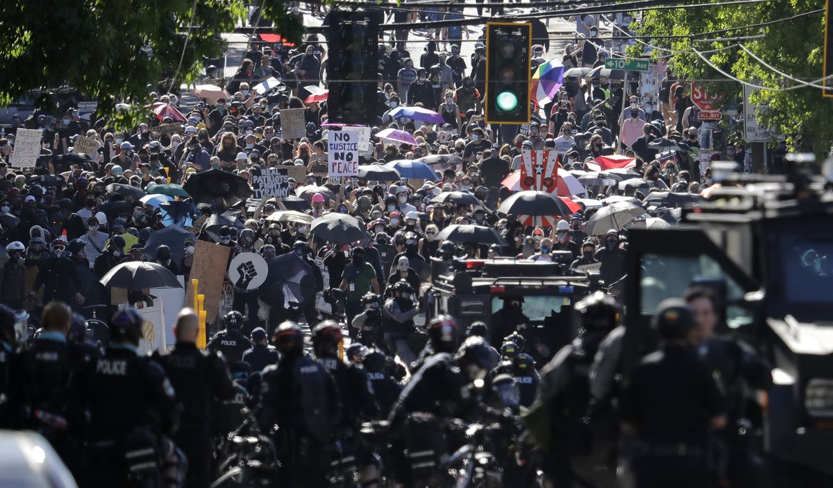 Police clash with protesters on July 25 during a Black Lives Matter protest near the Seattle Police East Precinct headquarters in Seattle.  (Ted S. Warren)