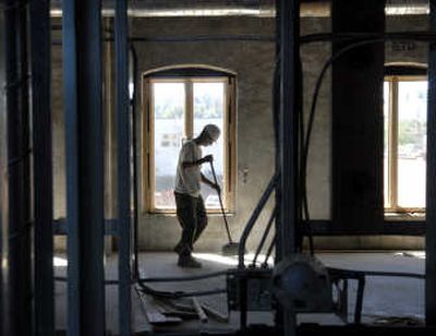 
Kevin Mason of RenCorp sweeps out a unit at The Edge Lofts in the 100 block of East Sprague Avenue. 
 (Dan Pelle / The Spokesman-Review)