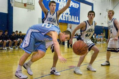 
Central Valley's Nick Ambrose loses the ball Tuesday night as he's unable to get around Gonzaga Prep's defense at G-Prep. 
 (Christopher Anderson / The Spokesman-Review)