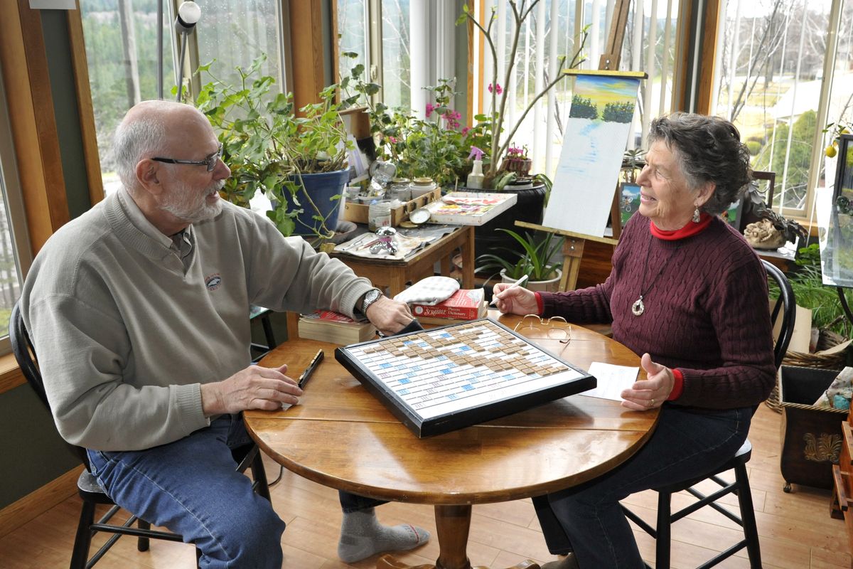 In between painting, Chuck and Alice Harmon like to play a game of Scrabble. Chuck began painting after he retired from the financial services business, while Alice has always made art. (Colin Mulvany)