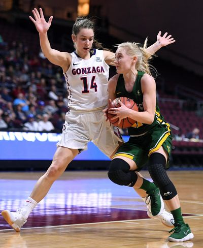 Gonzaga guard Emma Stach (14) defends San Francisco guard Anna Seilund (21) as she heads toward the basket during a West Coast Conference Basketball Championships women's semifinal game, Mon., March. 5, 2018, at Orleans Arena in Las Vegas. (Colin Mulvany / The Spokesman-Review)
