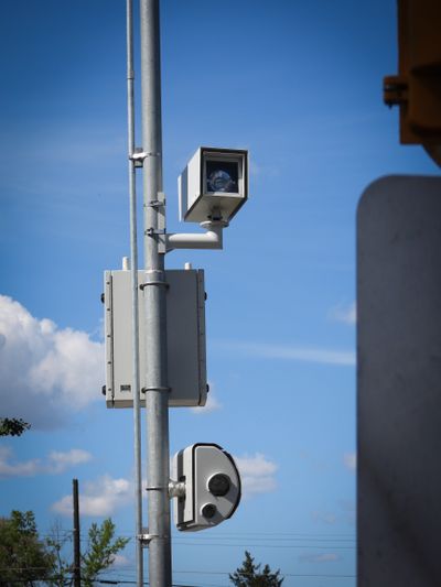 The speed camera system hangs on a post next to North Nevada Street, a block north of Longfellow Elementary School, shown Thursday, May 13, 2021. The camera enforcement system was placed there to slow cars when students are coming and going from Longfellow.  (Jesse Tinsley/The Spokesman-Review)