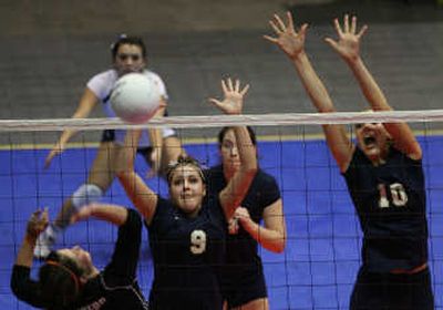 
Mead's Beth Altena and Emma Olgard attempt a block against GSL rival Lewis and Clark. Special to 
 (Rajah Bose Special to / The Spokesman-Review)