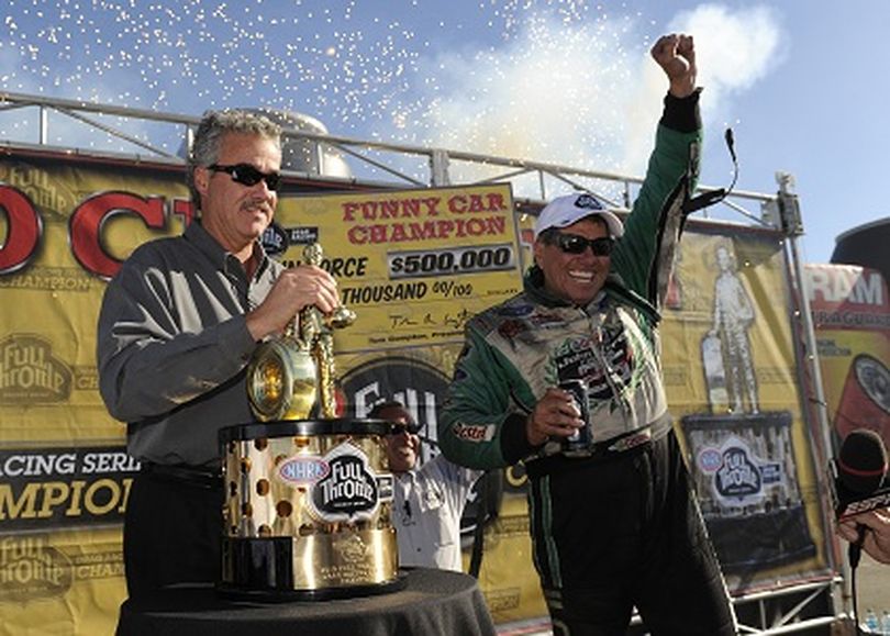 John Force enjoys his 15th world championship. (Photo courtesy of NHRA)