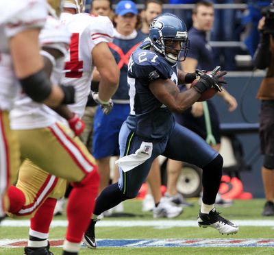Seattle’s Jordan Babineaux returns an interception of a pass by 49ers quarterback Alex Smith 20 yards in the first quarter. (Associated Press)