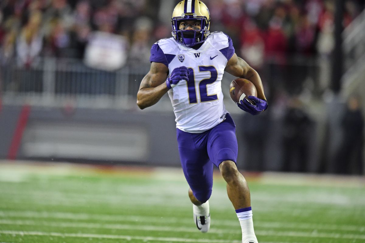 Washington running back Dwayne Washington is off and running on one of his two long touchdown sprints – this one on the second play of the game. (Tyler Tjomsland)