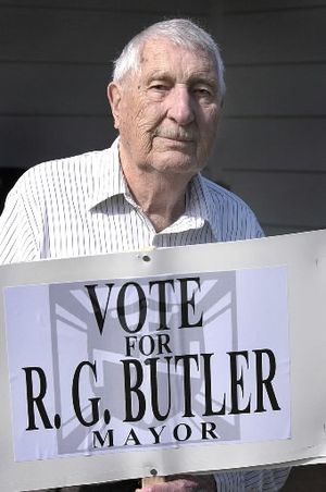 Aryan Nations founder Richard G. Butler holds a sign outside his home in Hayden, Idaho, Oct. 1, 2003, as he was campaigning for mayor of Hayden. Butler has died at the age of 86, authorities said. Deputies responding to a call at Butler's home found him dead in his bed about 11:20 a.m., Wednesday, Sept. 8, 2004. He appeared to have died peacefully in his sleep, Kootenai County Sheriff's Capt. Ben Wolfinger said. (AP Photo/Jeff T. Green/File) 
