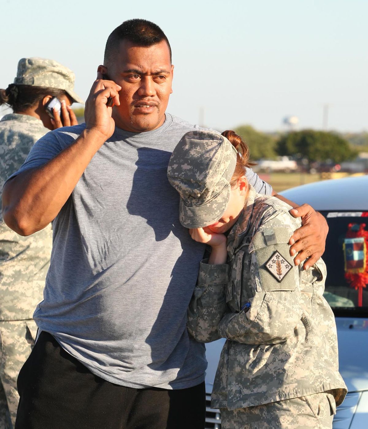 Staff Sgt. Fanuaee Fea, 32, comforts Savannah Green, 23, after Thursday’s shooting at Fort Hood, Texas.  (Associated Press / The Spokesman-Review)