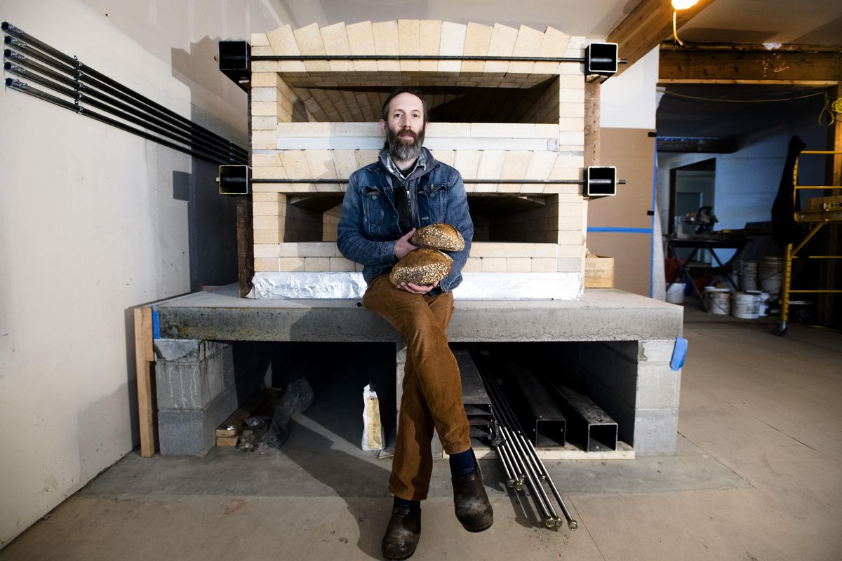 Shaun Thompson Duffy, owner and baker at Culture Breads, poses for a photo with his new oven at the shop’s soon-to-open location at 1026 E. Newark Ave., in December, in Spokane’s South Perry neighborhood. (Tyler Tjomsland / The Spokesman-Review)