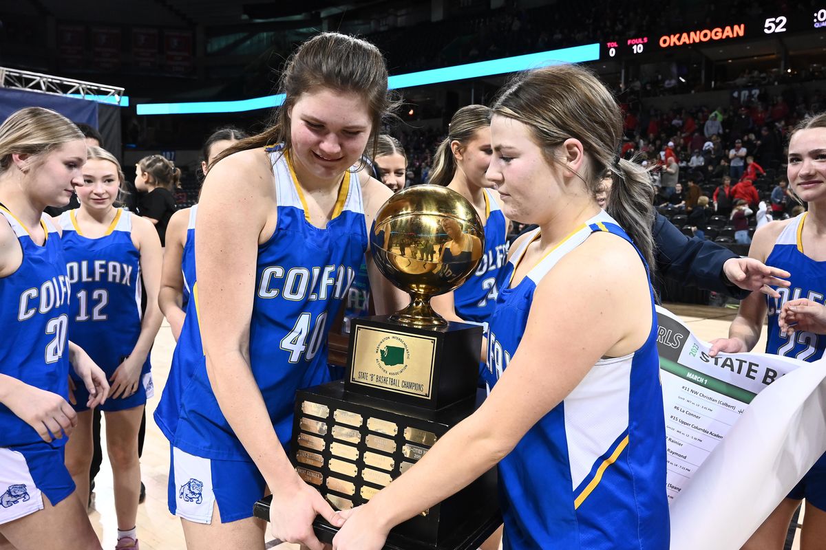 Colfax celebrates a 55-50 win over Okanogan in the State 2B girls basketball tournament championship Saturday at the Arena.  (James Snook)