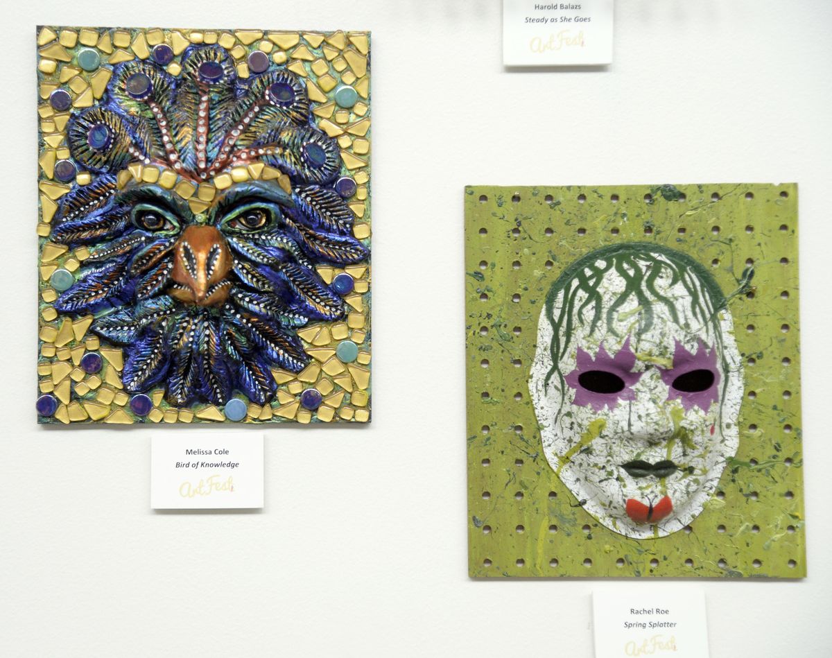 Masks decorated by artists Melissa Cole, left, and Rachel Roe part of the Face-Off mask project which will be displayed at ArtFest. (Jesse Tinsley / The Spokesman-Review)
