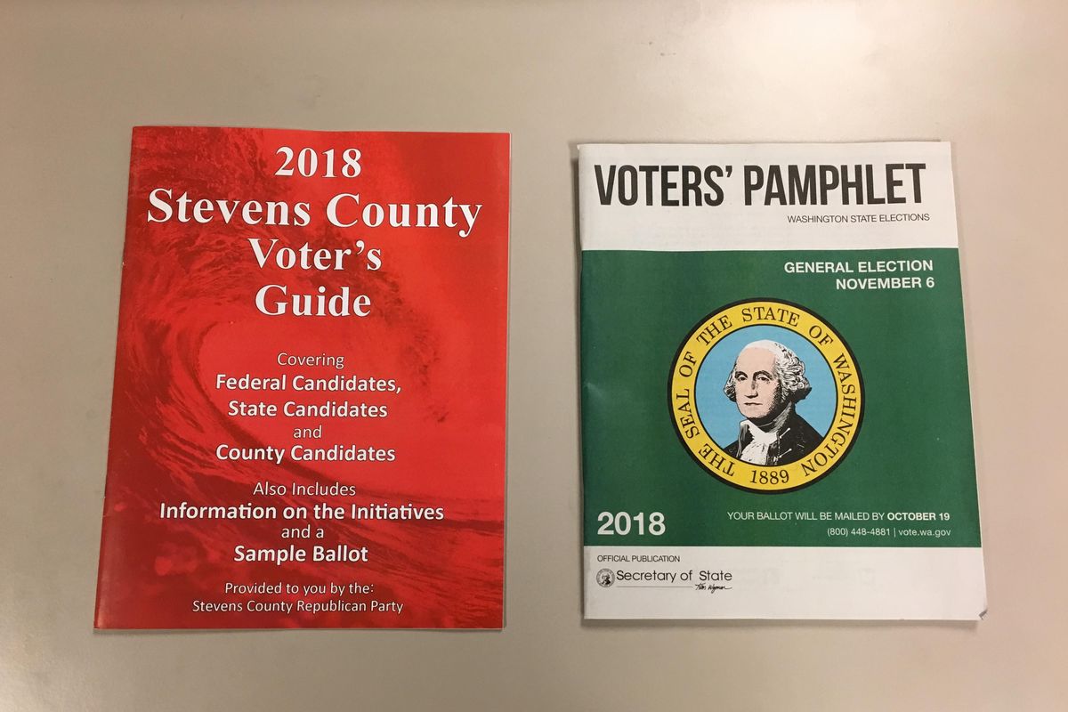 A voters guide mailer prepared by the Stevens County Republican Party is shown alongside an official state voters pamphlet from the Washington Secretary of State’s Office on Tuesday, Oct. 30, 2018. The Secretary of State’s office said it will not pursue a complaint filed by the state’s Democratic Party alleging the mailer was “deceptively similar” to the official document. (Kip Hill / The Spokesman-Review)