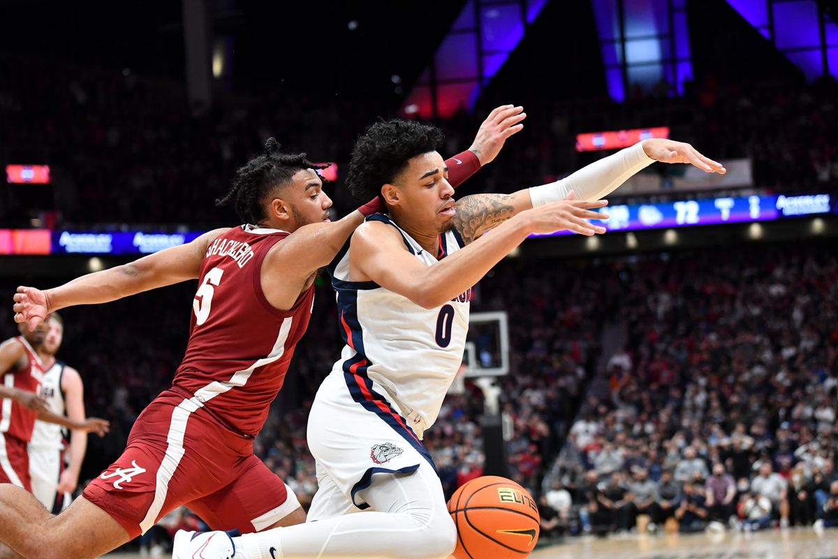 Alabama’s Jaden Shackelford, left, who scored a game-high 28 points, collides with Gonzaga’s Julian Strawther while chasing a loose ball during the second half Saturday.  (Tyler Tjomsland/The Spokesman-Review)