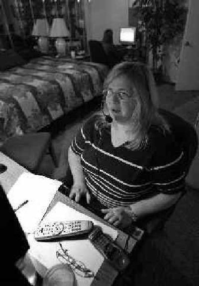 Nancy Allor works from her Arlington, Texas, home Friday. Americans dialing for customer service are increasingly being connected to workers like Allor — call center agents working from home.
(Associated Press / The Spokesman-Review)