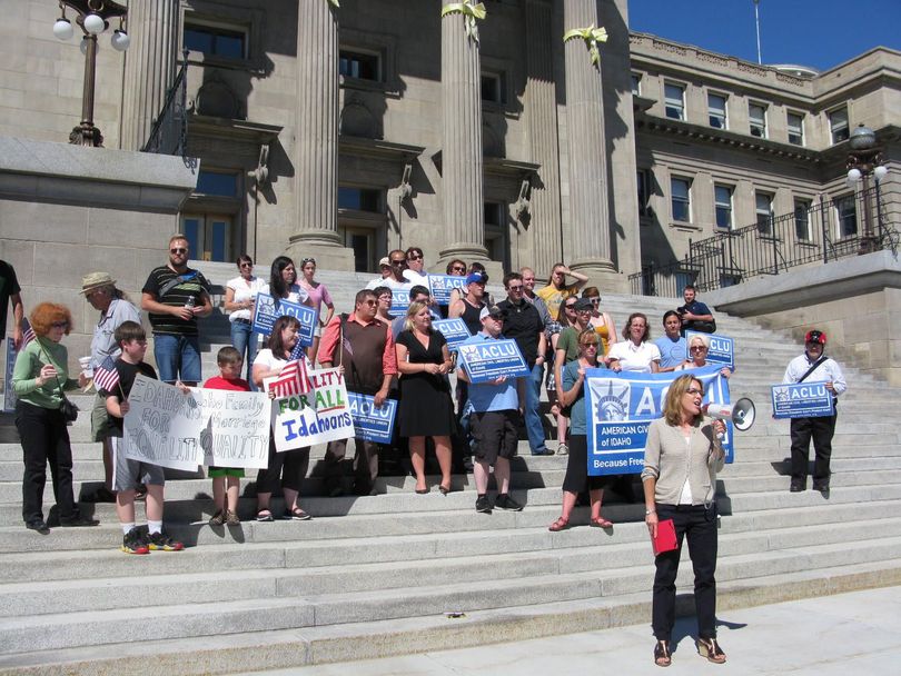 Kim Beswick addresses the crowd at a rally supporting the U.S. Supreme Court rulings on same-sex marriage, on the steps of Idaho's state Capitol on Wednesday afternoon. (Betsy Russell)