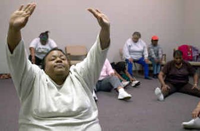 
Exercise group member Erika Neal stretches after a workout with her group  in St. Louis, Mo.
 (KRT / The Spokesman-Review)