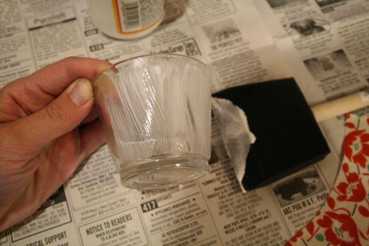 Brush a thin layer of decoupage glue on the outside of the candle holder. (Megan Cooley)