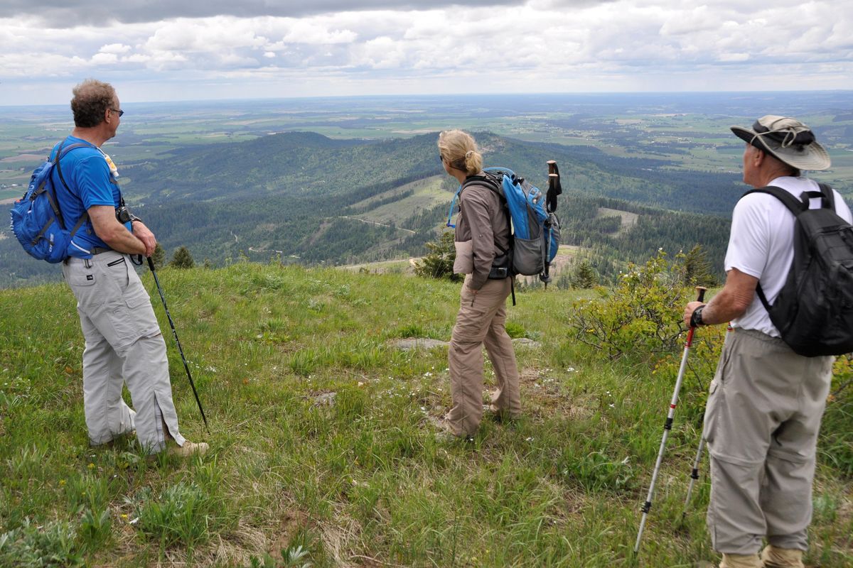 Hikers enjoy the westward view from near the top of the Mica Peak Conservation Area. (Rich Landers / The Spokesman-Review)