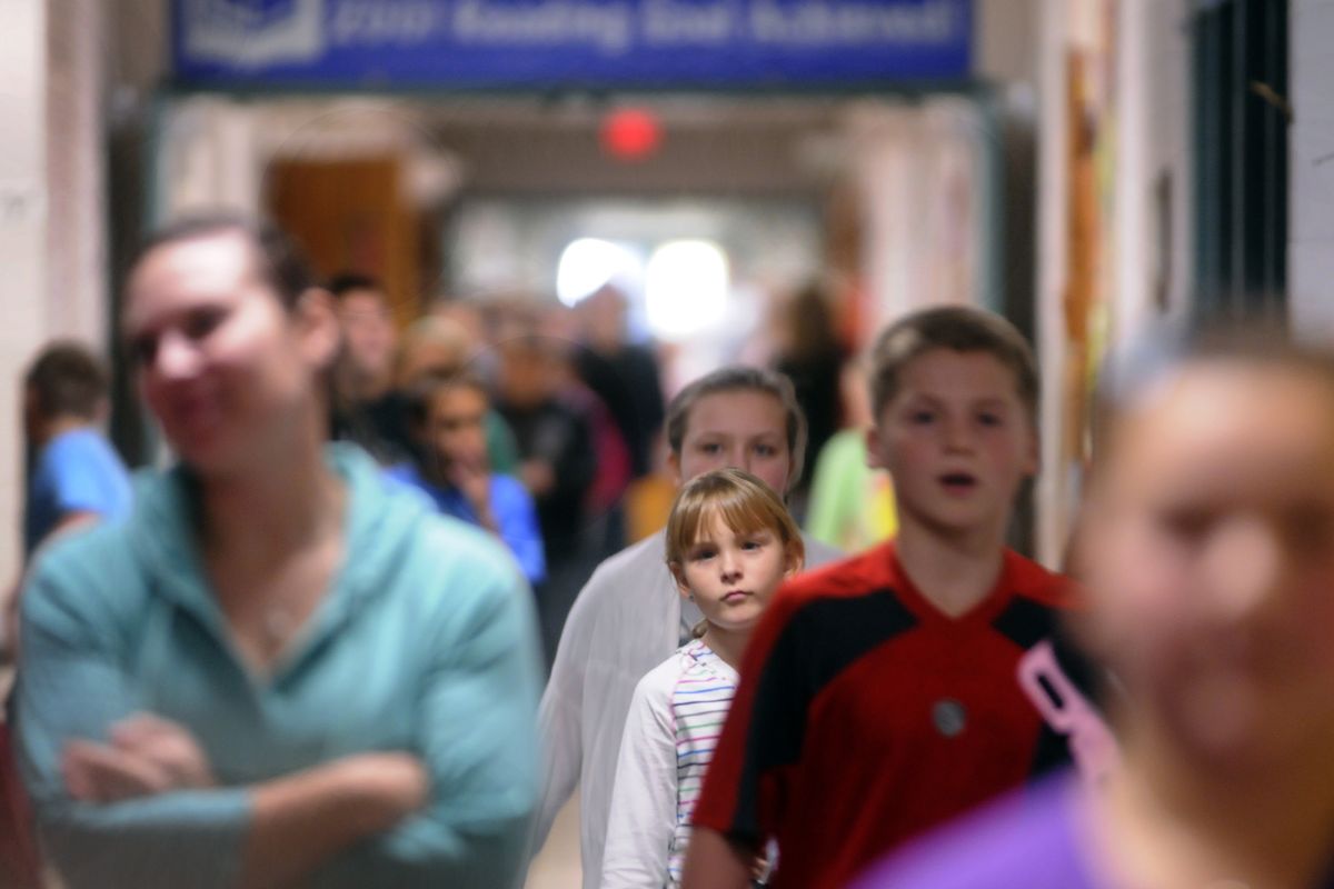 Fifth-graders and eighth-graders make their way down the main hallway at East Valley’s Continuous Curriculum School on (J. Bart Rayniak)