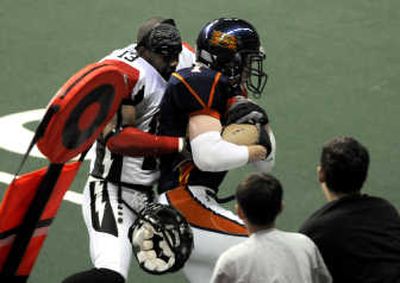 
Stockton's Shannon Davis (13) looses his helmet trying to put a hit on Spokane's Andy Olson. The Spokesman Review
 (DAN PELLE The Spokesman Review / The Spokesman-Review)