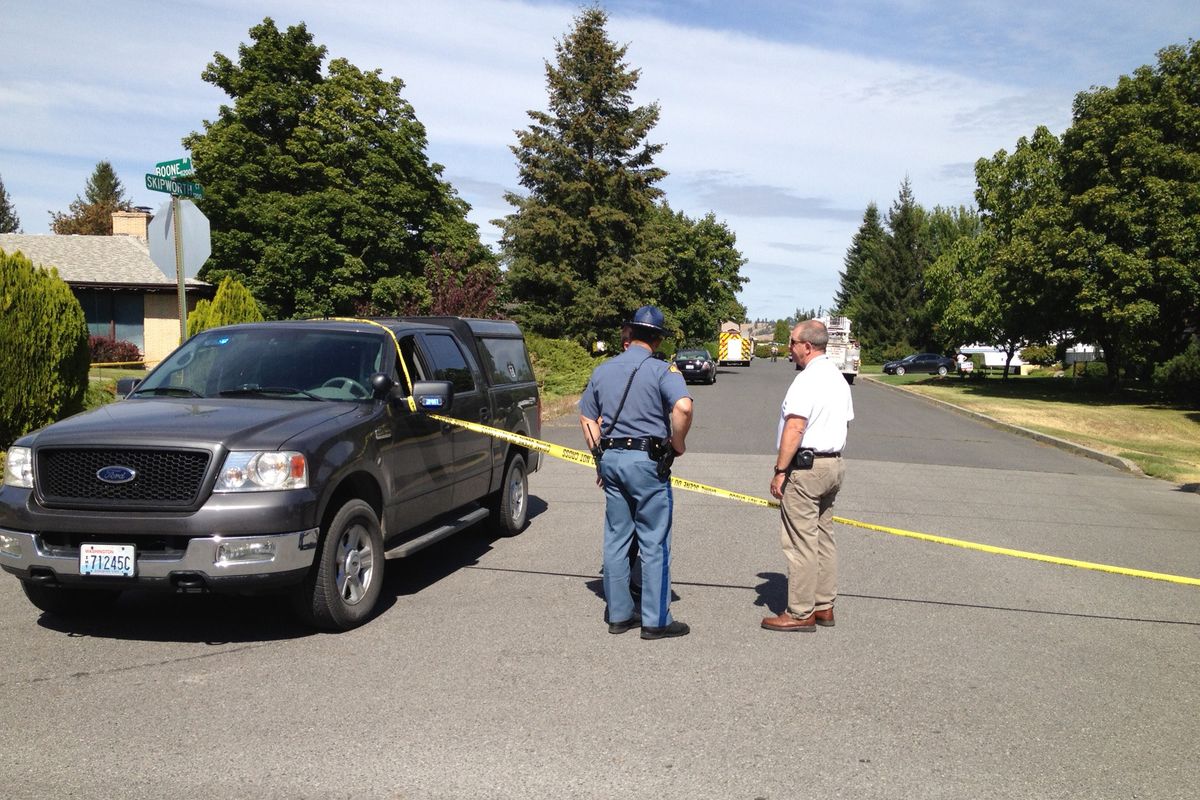 Authorities guard the scene of an officer-involved shooting reported on North Skipworth Court in Spokane Valley. This photograph looks north on Skipworth from Boone Avenue. (Colin Mulvany)