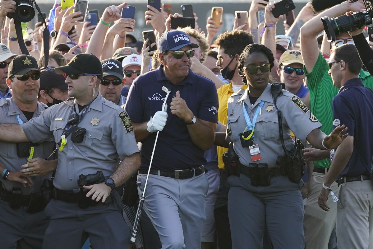 Phil Mickelson makes his way through fans on the 18th fairway Sunday during the final round of the PGA Championship on the Ocean Course in Kiawah Island, S.C.  (Matt York)
