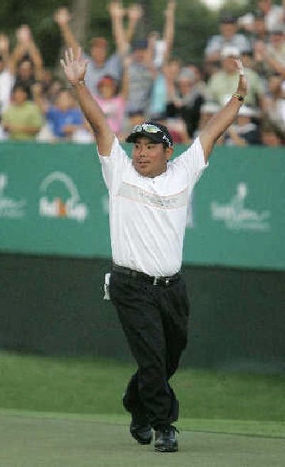 
Tadd Fujikawa, 16, celebrates eagle putt on the 18th green.
 (Associated Press / The Spokesman-Review)