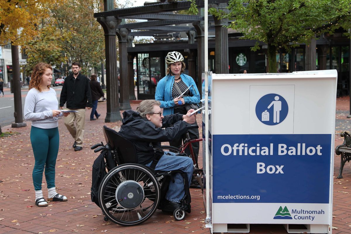 Voters drop off ballots at Pioneer Courthouse Square in Portland. (Associated Press)