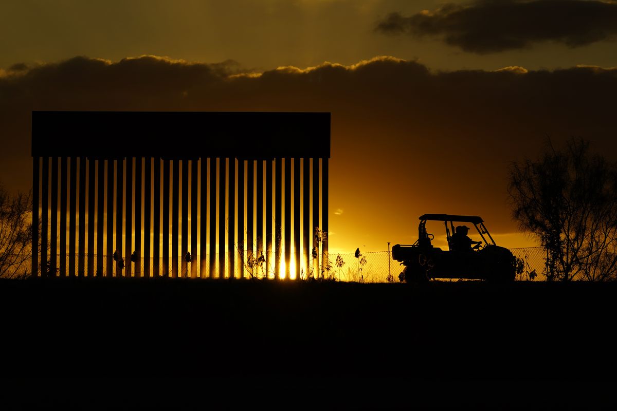 Authorities pass a border wall construction site on Nov. 16 in Mission, Texas. (Eric Gay)