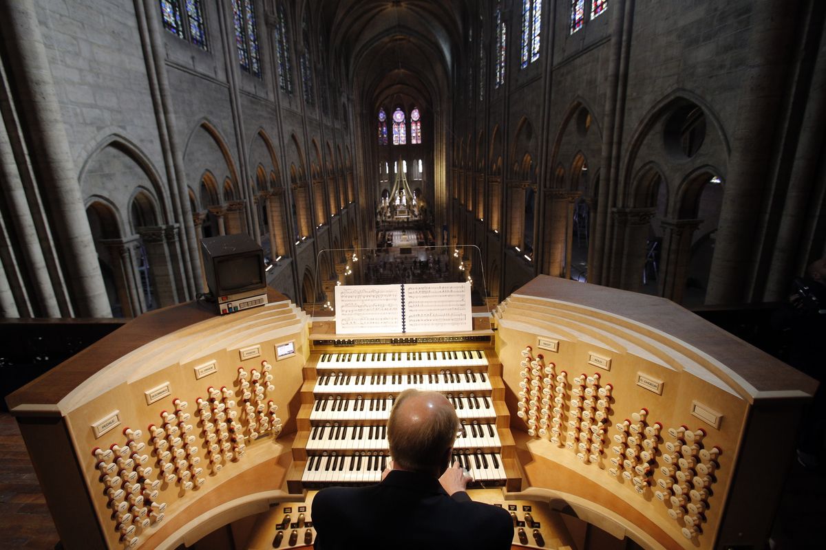 Philippe Lefebvre, 64, plays the organ at Notre Dame cathedral in Paris in May 2013.  (Christophe Ena)