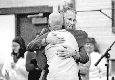 
Lakes Middle School teacher and heart transplant patient Dave Eubanks, back turned, hugs Dr. Timothy Icenogle after both were introduced at an assembly on Friday.  Icenogle put in Eubanks' donor heart in February. 
 (Photos by JESSE TINSLEY / The Spokesman-Review)