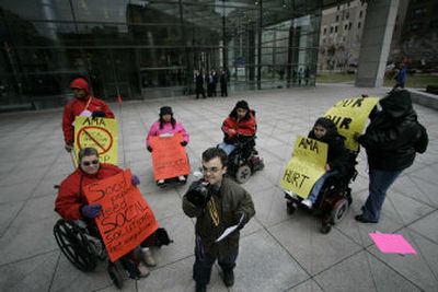 
Protesters outside the American Medical Association building Thursday in Chicago demonstrate  to persuade the AMA to condemn the treatment of a severely brain-damaged girl to keep her child-sized and easier to care for. 
 (Associated Press / The Spokesman-Review)