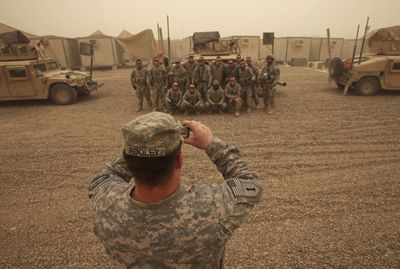 Army soldiers from the 1st Squadron, 7th Cavalry, Fort Hood, Texas pose for a photograph at a U.S.  base on the outskirts of Baghdad, Iraq, on Sunday. A heavy sandstorm has blanketed the capital.  (Associated Press / The Spokesman-Review)