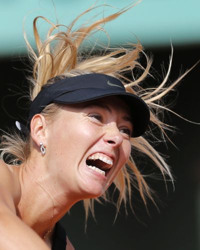 Maria Sharapova serves to China's Peng Shuai during a 6-2, 6-1 win on Saturday. (Associated Press)