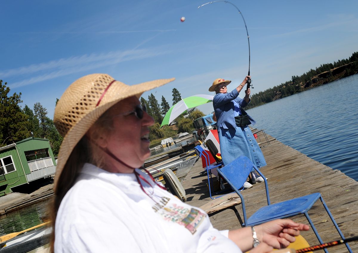 Bev Reid and her aunt Dorothy Snethen,  of Kennewick, fish from the dock of Bunkers Resort on Williams Lake south of of Cheney on Monday afternoon. (Rajah Bose / The Spokesman-Review)