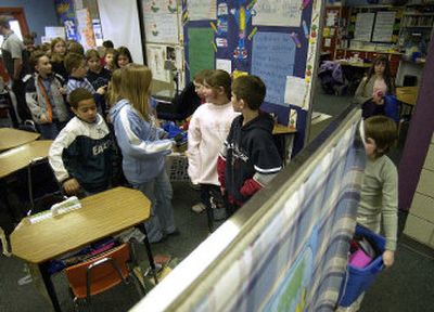Ponderosa Elementary fourth-graders line up to head to lunch Thursday. The school was built in 1979 following the open-concept design, but now Central Valley School District is asking voters to pay for a remodel at Ponderosa to erect walls between classrooms.
(Liz Kishimoto / The Spokesman-Review)