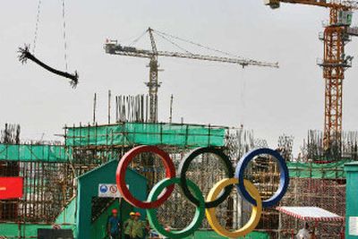 
The Olympic rings stand near the site where construction is under way for the Olympic stadium in Beijing earlier this year. Beijing's spending bonanza for the 2008 Olympics is proving a disappointment to foreign companies, who say they are being effectively locked out of most contracts. 
 (Associated Press / The Spokesman-Review)