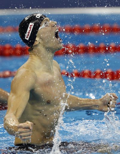 Brazil's Cesar Cielo celebrates after winning gold medal in men's 50-meter butterfly at FINA Swimming World Championships. (Associated Press)