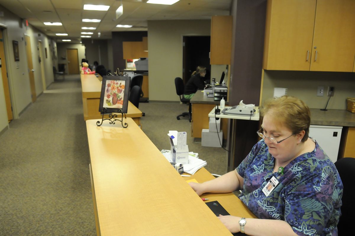 Claire Houghton, a certified medical assistant, works in the newly remodeled urology clinic at the Rockwood Clinic satellite office in the Sacred Heart Doctors Building on Friday. Rockwood will soon have to move, despite having just completed the remodel. (Jesse Tinsley)