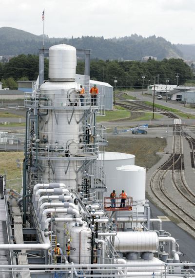 In this August 2007  photo, workers stand on the distillation tower of the then-new Imperium biodiesel plant in Hoquiam, Wash. Imperium Chief Executive Officer John Plaza has laid off 90 of his 120 workers.  (File Associated Press / The Spokesman-Review)