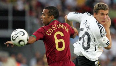 
Portugal's Costinha, left, and Germany's Lukas Podolski vie for control of the ball during the World Cup third-place match. 
 (Associated Press / The Spokesman-Review)