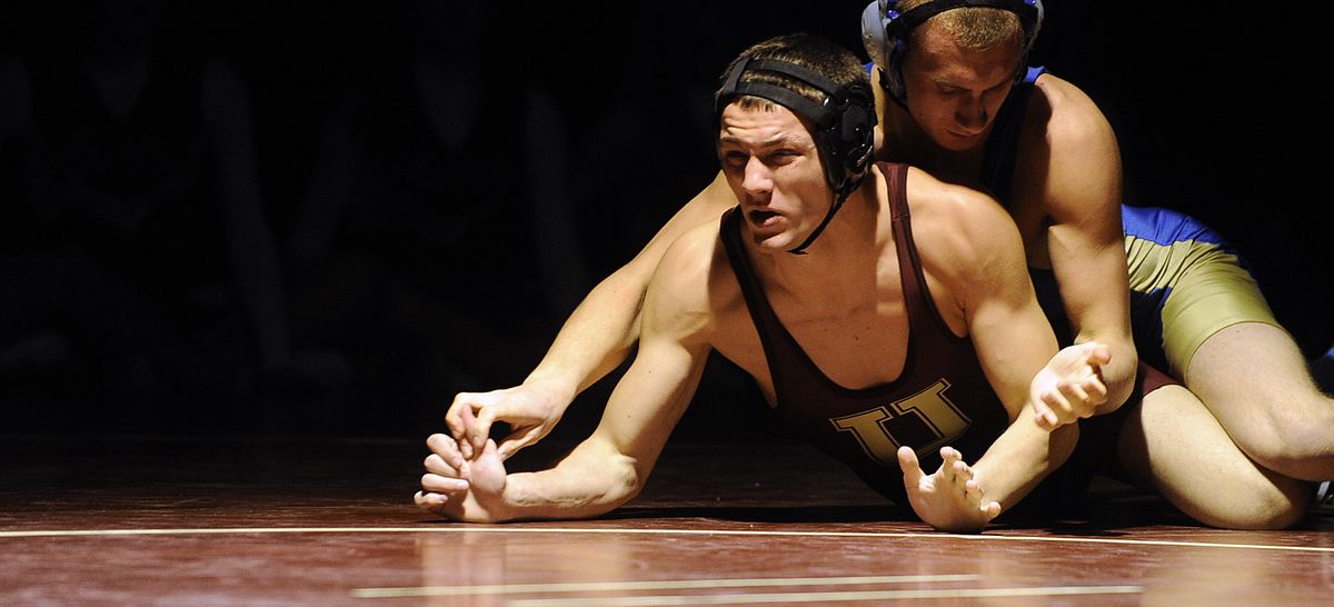 Deer Park’s Dylan Miller stays behind and in control of Jacob Patschowski of U-Hi during their match Thursday. (Christopher Anderson)