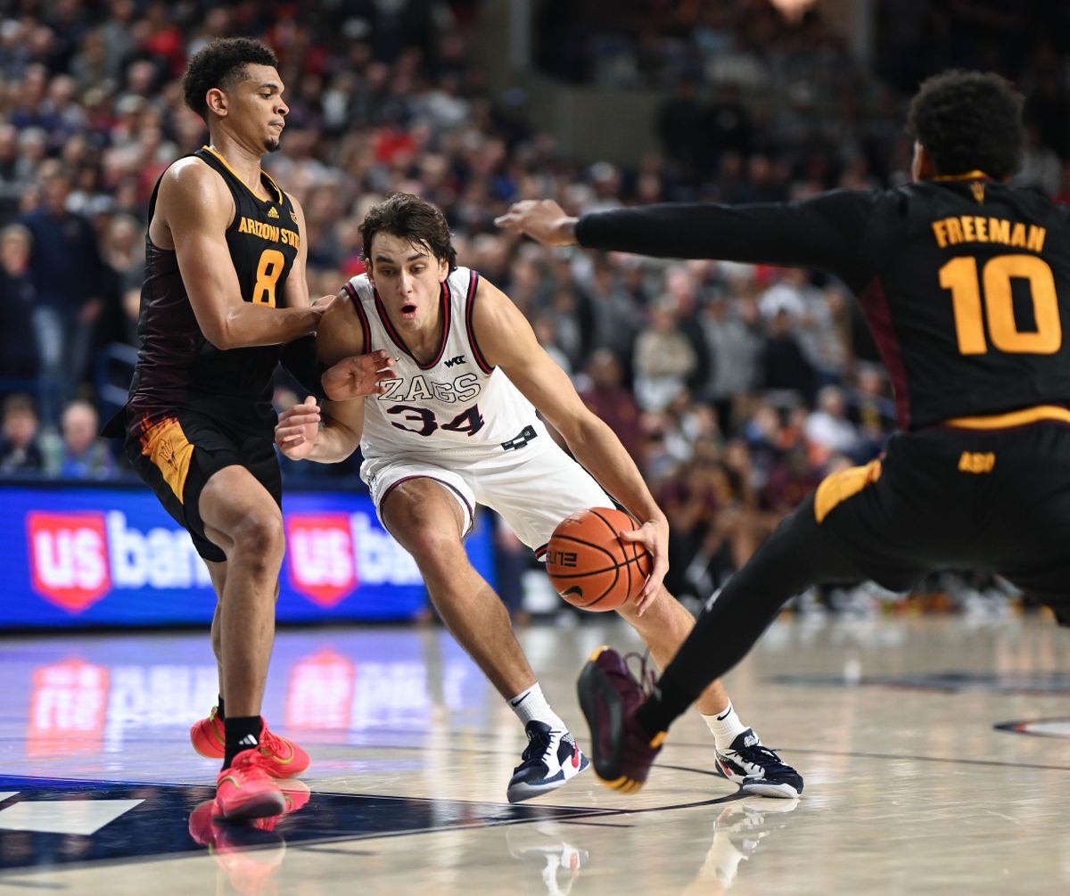 Gonzaga forward Braden Huff (34) drives the ball into the key as Arizona State forward Basheer Jihad (8) and guard BJ Freeman (10) defend during the second half of a NCAA college basketball game, Sunday, Nov. 10, 2024, at the McCarthey Athletic Center.  (COLIN MULVANY)