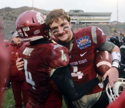 WSU’s Luke Falk, right, and Charleston White celebrated a Sun Bowl win in December. On Saturday, White was able to celebrate an interception against his teammate in WSU’s scrimmage. (Victor Calzada / Associated Press)
