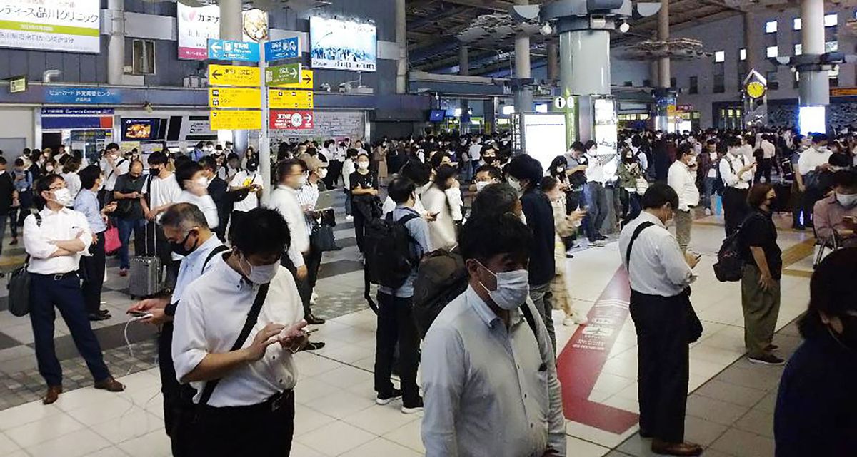 Passengers are seen outside the entrance of JR Shinagawa station as the railway company makes safety check following an earthquake, in Tokyo, Thursday, Oct. 7, 2021. A powerful earthquake shook the Tokyo area on Thursday night, but officials said there was no danger of a tsunami.  (SUB)