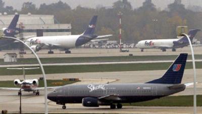 
A United Airlines Shuttle jet taxis at Chicago's O'Hare International Airport on Monday. United's parent company, UAL Corp., reported a third-quarter net loss Monday of $1.7 billion, citing the heavy costs of restructuring its aircraft leases as it nears the completion of its overhaul. 
 (Associated Press / The Spokesman-Review)