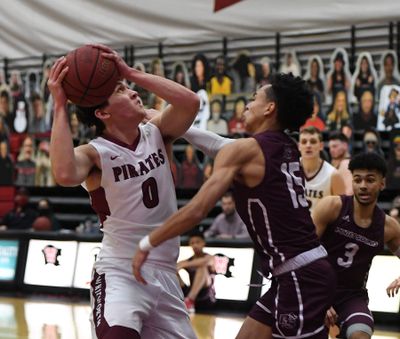 Whitworth guard Jake Holtz (0) eyes the basket as Puget Sound guard Jourdan Joseph (15) defends during the first half of a college basketball game, Friday, Feb. 12, 2021, at Whitworth University.  (Colin Mulvany/THE SPOKESMAN-REVIEW)