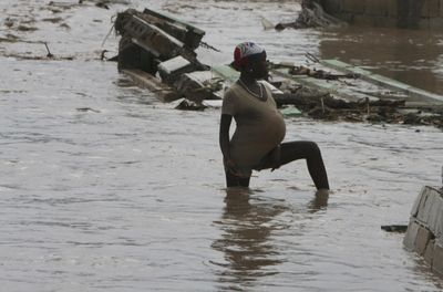 A pregnant woman stands in a flooded street after Tropical Storm Hanna hit the area in Gonaives, Haiti, on Wednesday.  (Associated Press / The Spokesman-Review)