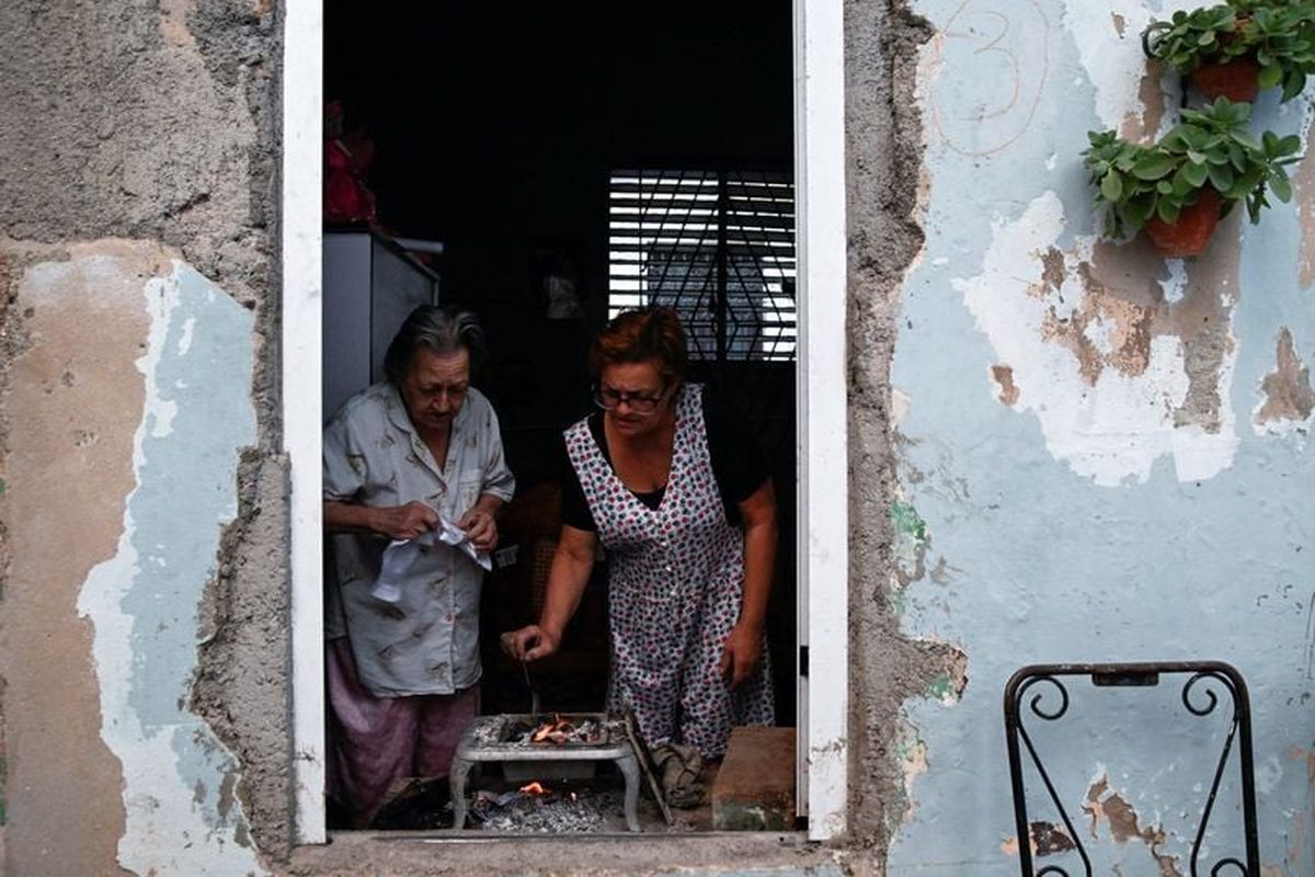 Mirna Clavijo, 84, and her daughter Isabel Gutierrez, 61, cook dinner as Cuba